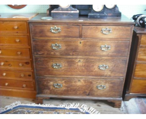 A George III oak chest, the rectangular top with moulded edge over two short and three graduated long drawers, each with cut 