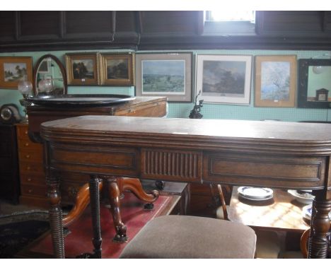 A George III mahogany supper table, the D-shape folding top with double gate on ring turned tapering supports.