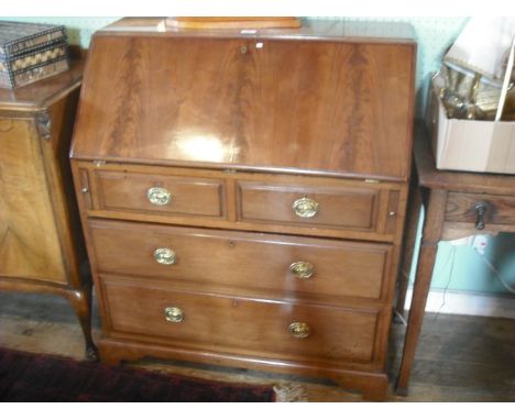 An Edwardian mahogany bureau, the fall with moulded edge enclosing a fitted interior over two short and two long drawers on b