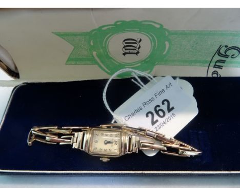 A lady's 9 carat gold cased Rotary wristwatch on an expanding bracelet.