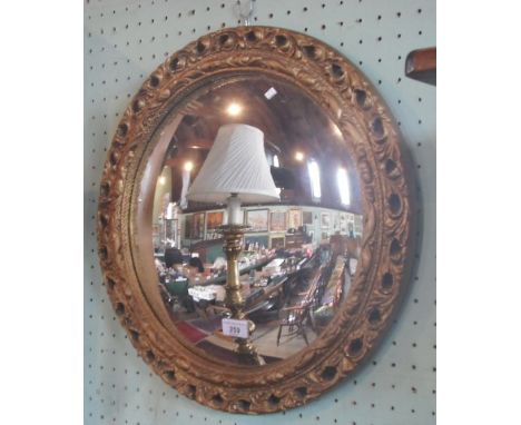 A gilt composite circular wall mirror with convex plate.