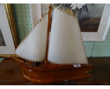 A desk lamp fashioned as a single masted sailing boat.