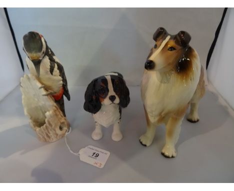 A Beswick model of a tricolour King Charles spaniel, an unmarked model of a Rough Collie and a Goebel model of a woodpecker.