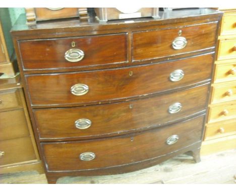 An early 19th century mahogany veneered chest of bow front form, having two short and three graduated long drawers on bracket