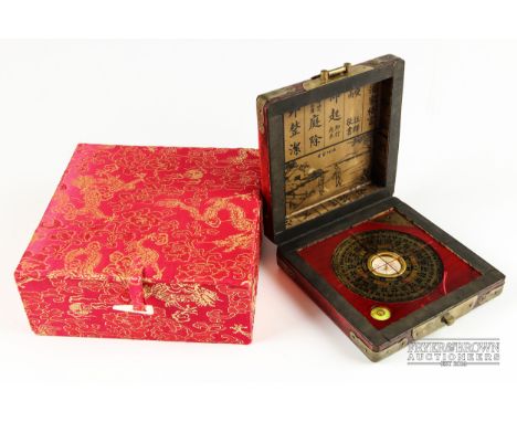 A Chinese feng shui compass, or lo-pan, in red leather case