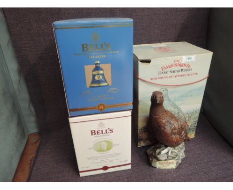 Three ceramic decanters of Blended Scotch Whisky, Bells 8 Year old 75th Birthday of Queen Elizabeth II, Bells 8 Year Old Chri