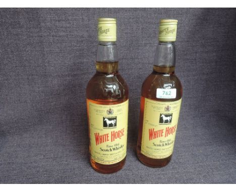 Two bottles of White Horse Blended Scotch Whisky, 1970's no 5277626, 70 proof, 26 2/3fl oz, screw top and 1980's no7532021 40