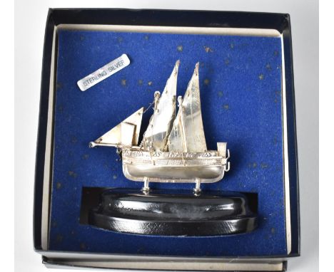 A Middle Eastern Sterling Silver Model of a Two Masted Dhow  on Oval Ebonized Plinth, 11cms Wide 