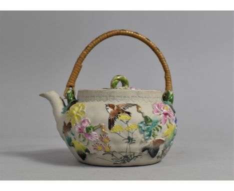 A Yixing Teapot Decorated in Shallow Relief with Multicoloured Enamels Depicting Birds and Flower 