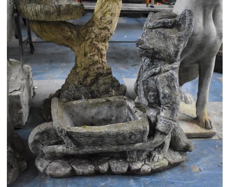 A Reconstituted Stone Garden Planter in the Form of a Fox Pushing a Wheelbarrow, 51cms Wide and 52cms Tall 