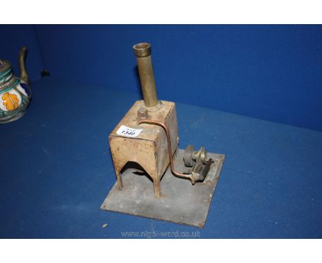 A stationary steam engine having oscillating cylinder, the tin-plate firebox with double wick burner having a brass finished 