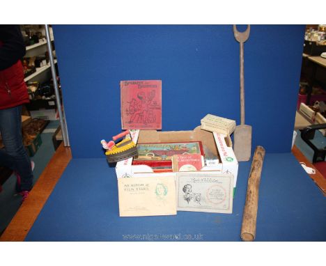 A quantity of children's games and books, rainmaker, wooden seaside spade, two cigarette albums, toy scales, iron, etc.