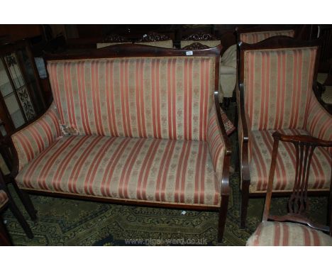 An Edwardian Mahogany show frame three piece Salon Suite comprising two seater sofa and two armchairs in salmon pink ground R