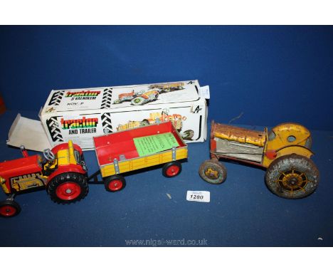 A clockwork Tractor and trailer in box and a Czech made toy Tractor