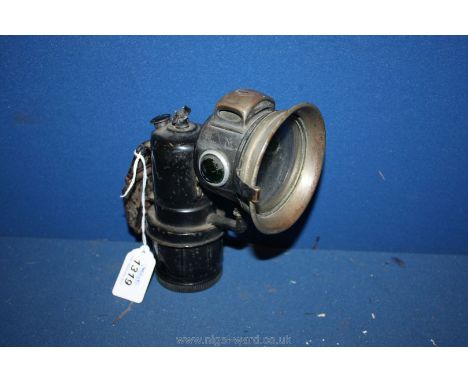 A ''Miller British Made'' Carbide Motorcycle head Lamp in original condition and having faceted green side prisms