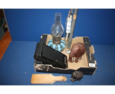 A quantity of miscellanea including blue oil lamp, wooden elephants, camera, cheese thermometer, butter pats, etc.