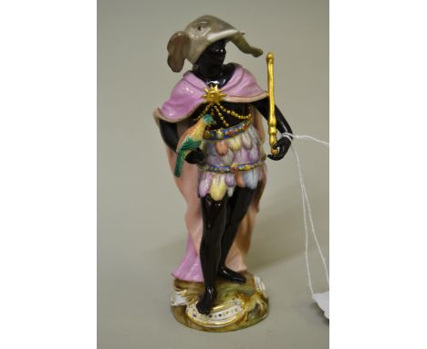Meissen figure emblematic of Africa wearing an elephant headdress and holding an exotic bird and gold staff, 15cm high (some 