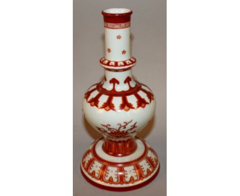 AN UNUSUAL CHINESE IRON-RED DECORATED CANDLESTICK, the baluster body with a ribbed neck and supported on a splayed bell-form 