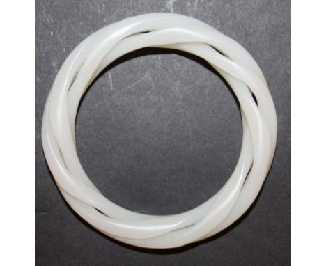 A CHINESE WHITE JADE-LIKE THREE-STRAND BANGLE, approx 3.25in diameter, the inner rim approx. 2.3in diameter.