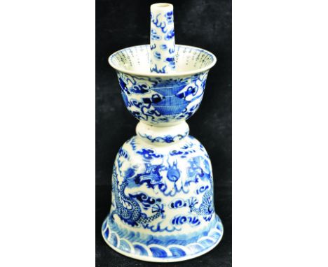 A 19TH CENTURY CHINESE BLUE & WHITE PORCELAIN DRAGON JOSS STICK HOLDER, of larger than average size, the bell-form lower sect