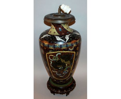 A LARGE 19TH CENTURY JAPANESE MEIJI PERIOD CLOISONNE VASE, mounted as a lamp and supported on a carved hardwood stand, the si