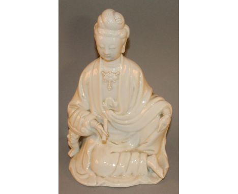 A CHINESE BLANC-DE-CHINE FIGURE OF GUANYIN, modelled reclining and bearing a scroll in one hand, 10in high.
