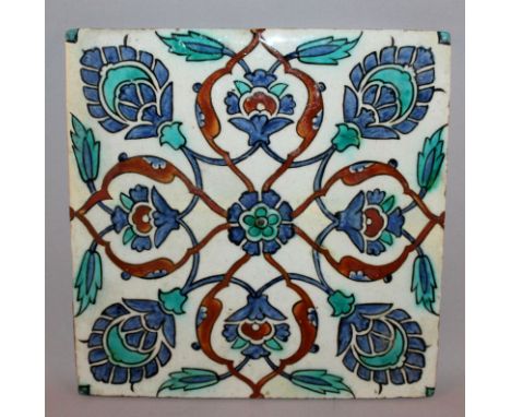 A TURKISH ISNIK TILE, 19th Century or earlier, decorated in blue, turquoise and red with stylised formally arranged flowerhea