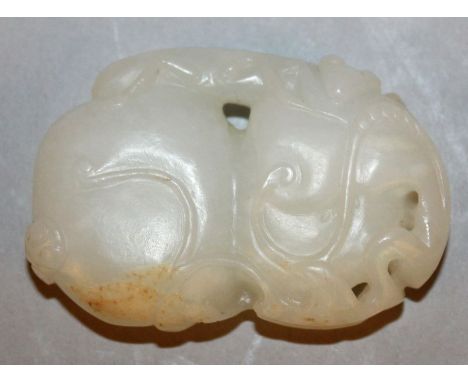 A CHINESE WHITE JADE-LIKE PENDANT, in the form of a leaf-shrouded gourd surmounted by a monkey, 2.1in high.