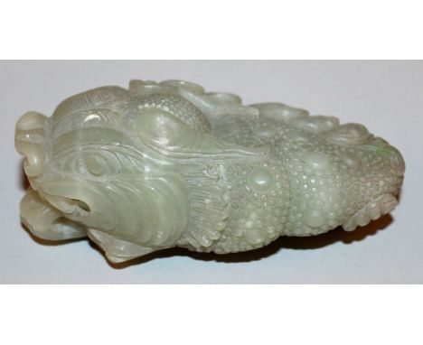 A CHINESE GREEN JADE-LIKE MODEL OF A THREE-LEGGED MYTHICAL TOAD, naturalistically carved with protruding tongue and scaly ski