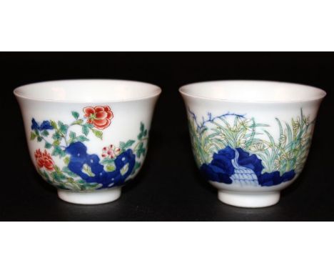 A PAIR OF GOOD QUALITY CHINESE FAMILLE ROSE PORCELAIN CUPS, each painted with garden foliage and rockwork, each base with a K