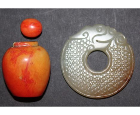 A CHINESE JADE BI DISC, carved in the form of a scaly dragon, 2.1in diameter; together with an ivory-like snuff bottle and st