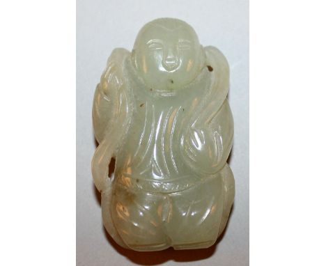 A 20TH CENTURY CHINESE CELADON JADE CARVING OF A STANDING BOY, a length of cloth draped around his shoulders, 2.3in high.