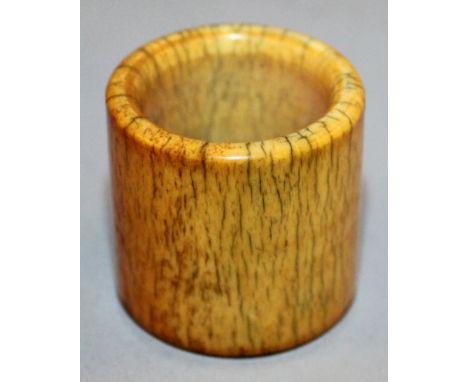 A CHINESE IVORY ARCHER’S RING, of good colour and with a profusion of faint age cracks, 1.1in long & also 1.1in diameter.