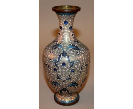 AN EARLY 20TH CENTURY WHITE-GROUND CHINESE CLOISONNE VASE, decorated with formal leafage reserved on a scroll ground, 9in hig