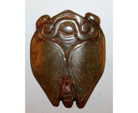 A CHINESE DARK GREEN JADE CICADA PENDANT, of flattened form, the engraving with lighter colouring, 2.25in high.