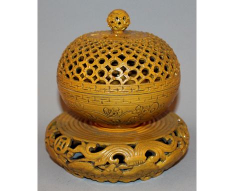 AN UNUSUAL CHINESE OCHRE GLAZED PIERCED CERAMIC CENSER ON STAND, the base with a Qianlong seal mark, 7in high overall.