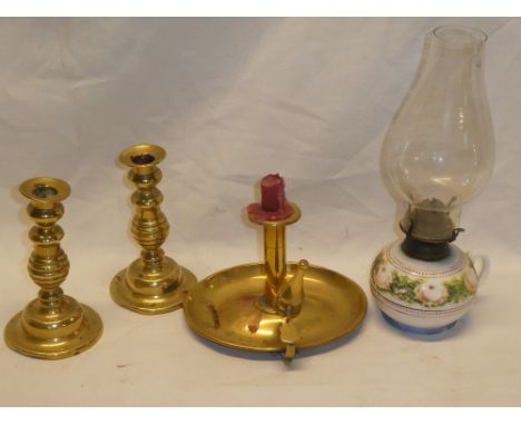 An old brass oval chamber candlestick with snuffer, a pair of small brass ejector candlesticks and a chamber oil lamp with op