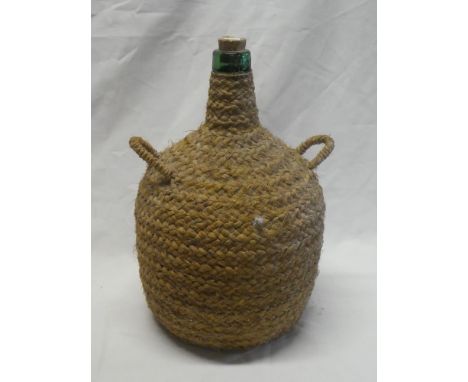 A 19th century green glass bottle flask with stringwork binding