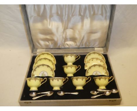 A Royal Albert bone china tea set comprising six tea cups with floral yellow and gilt decoration, six saucers and six silver-