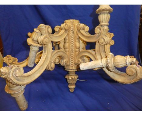 A painted wood six-branch ceiling chandelier with twelve electric light fitments