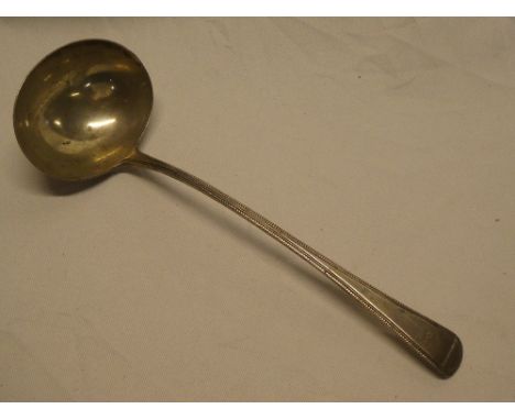 A George III silver serving ladle with engraved crest, London marks 1803