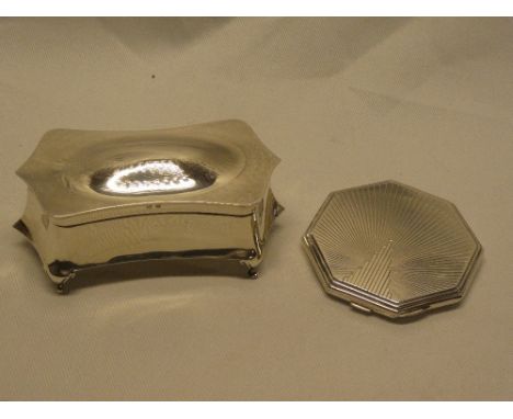 A George V silver ring box with hinged lid on scroll feet, Birmingham marks 1913 and one other silver octagonal compact (2)