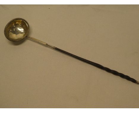 An 18th century silver oval toddy ladle with reeded decoration,  engraved initials and  whale bone handle 