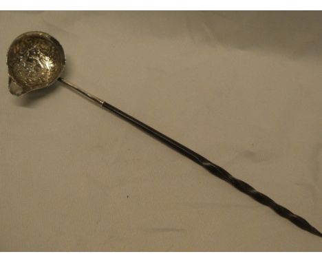 A Georgian silvered toddy ladle with raised floral decoration and whale-bone handle