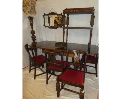 An unusual 1930/40's suite of carved oak matching dining and lounge furniture comprising a rectangular draw leaf dining table