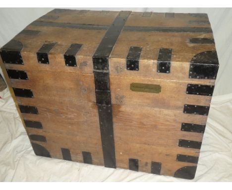 A 19th century metal-bound oak rectangular domed trunk with hinged lid and iron handles, 35" long x 27½" high