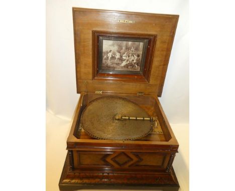 A Victorian polyphon to play 15½" discs in polished and carved burr-walnut rectangular brass mounted cabinet 22" wide x 13½" 