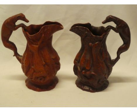 A pair of 19th century rustic glazed pottery tapered hunting jugs by Ferdinand Gerbing decorated in relief with dead game and