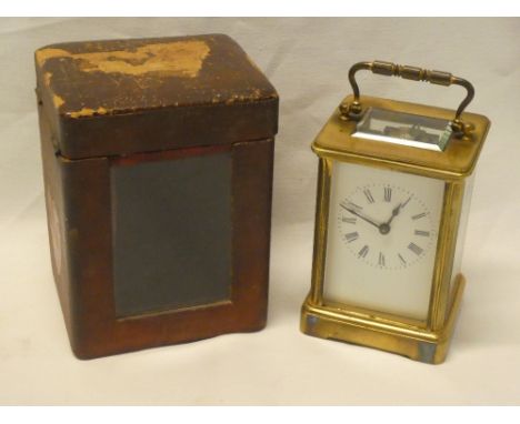 A French carriage clock with rectangular enamelled dial in brass traditional glazed case and Morocco leather travelling case