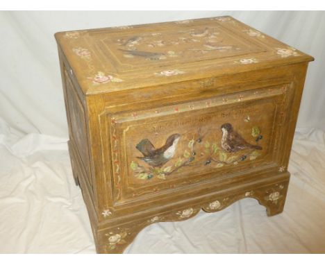 An unusual Continental painted oak rectangular trunk with hinged lid and bird and floral decoration on bracket feet